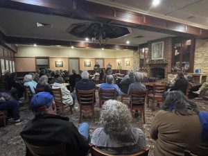 Group shot of 50+ attendees and 3 candidates